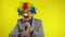 Clown businessman entrepreneur boss in wig shows tricks with money banknotes