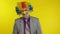 Clown businessman entrepreneur boss in wig at work. Halloween. Yellow background