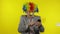 Clown businessman freelancer boss receives money income while using smartphone