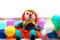 Clown between coloured balloons