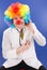 Clown doctor on blue with stethoscope