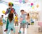 Clown entertains children at birthday party. Kids play with colorful ballons