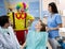 Clown entertains girl in dental ambulance