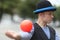 The clown juggles with red balls