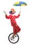 Clown riding a unicycle and holding an umbrella