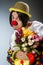 The clown with tulip flowers in funny concept