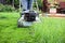 Clsoeup of a lawnmower cutting tall grass