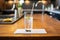 club soda glass with a cocktail stirrer on a modern bar mat