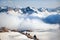 Clubs of fog and clouds move along slope of Mount Elbrus