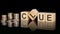 clue - text on wooden cubes on dark backround with coins. business concept