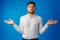 Clueless businessman gesturing he doesn`t know against blue background