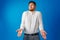 Clueless businessman gesturing he doesn`t know against blue background