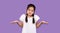 Clueless Korean Girl Shrugging Shoulders Standing Over Purple Studio Background