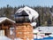 Clump of snow on a stylish forged pipe. Dawn at the Siberian Ski Resort Gornaya Salanga