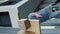 Clumsy caucasian delivery man falls to the ground and drops cardboard boxes. Vertical video