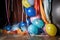 a cluster of balloons partially deflated and string-bound, thrown in a corner
