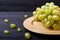 Cluster grapes at plate wooden board