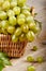 Cluster grapes in wicker basket with leaf