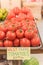 Cluster juicy tomatoes display at farmer market with price sign