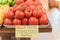 Cluster juicy tomatoes display at farmer market with price sign