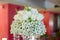 Cluster of pure white tulips set on a thick base bouquet of Baby`s-breath for a wedding reception