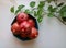 Cluster of ripe red pomegranates still attached in a blue bowl