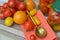 Cluster of small cherry tomatoes in a variety of colors on shabby table with russian khokhloma spoon