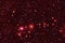 A cluster of stars and galaxies. In red. Elements of this image were furnished by NASA