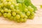Cluster of table white grapes with vine close-up