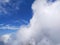 clustered white clouds with a clear blue sky