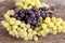 Clusters of grapes of different varieties in a wooden bowl