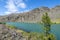 Clutha River with sun on scenic grassy slopes and turquoise rive