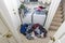 Cluttered Messy Laundry Room with Piles of Clothes