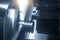 The CNC lathe machine groove cutting the metal pulley parts with lighting effect.