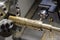 The CNC lathe,multi-tasking machine cutting the groove  slot at the brass shaft with the milling spindle by solid endmill tools.