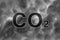 CO2 inscription on background of smog or smoke. Concept - reduction of carbon dioxide emissions into the atmosphere