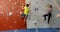Coach assisting woman in bouldering 4k
