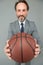 Coach career paths start here. Basketball coach grey background. Business coach hold basketball ball. Happy coach or