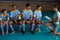 Coach discussing with volleyball players sitting on chairs