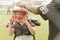 Coach help kid put on helmet prepare to play football