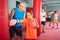 Coach helps the girl to correctly beat the punching bag