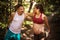 Coach helps a pregnant woman during exercises in the park