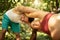 Coach helps a pregnant woman during exercises in the park