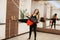 Coach helps woman practicing yoga on ropes stretching in gym. Fit and wellness lifestyle