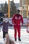 Coach at the ice rink teaches kids to skate