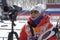 Coach of South Korea biathlon team instructs biathletes at shooting range of biathlon stadium during Junior biathlon competitions