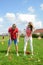 Coach teaches a student to play golf option to a young woman on a special playing field