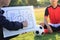 Coach training a tactic for asian teenager football player