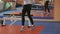 The coach in training throws a ball with a female kickboxer in the sport studio