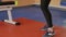 The coach in training throws a ball with a female kickboxer in the sport studio